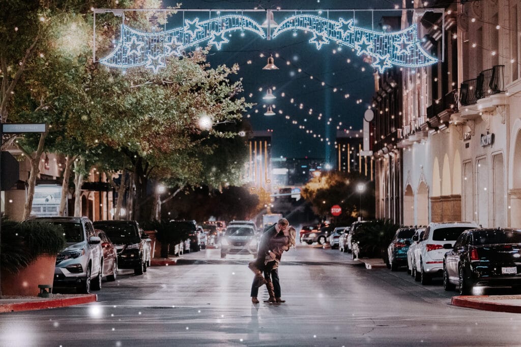 A man "dips" his wife in the middle of an empty street at Christmas Time at Town Square in Las Vegas.