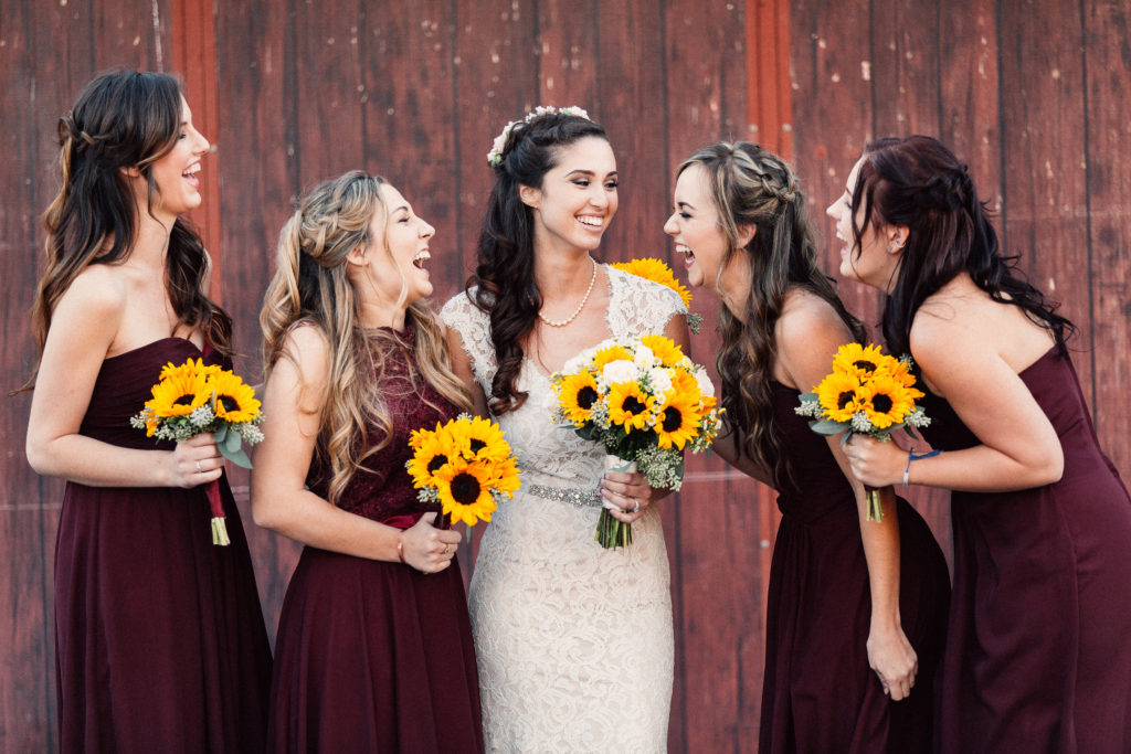 bride and bridesmaids laughing with each other