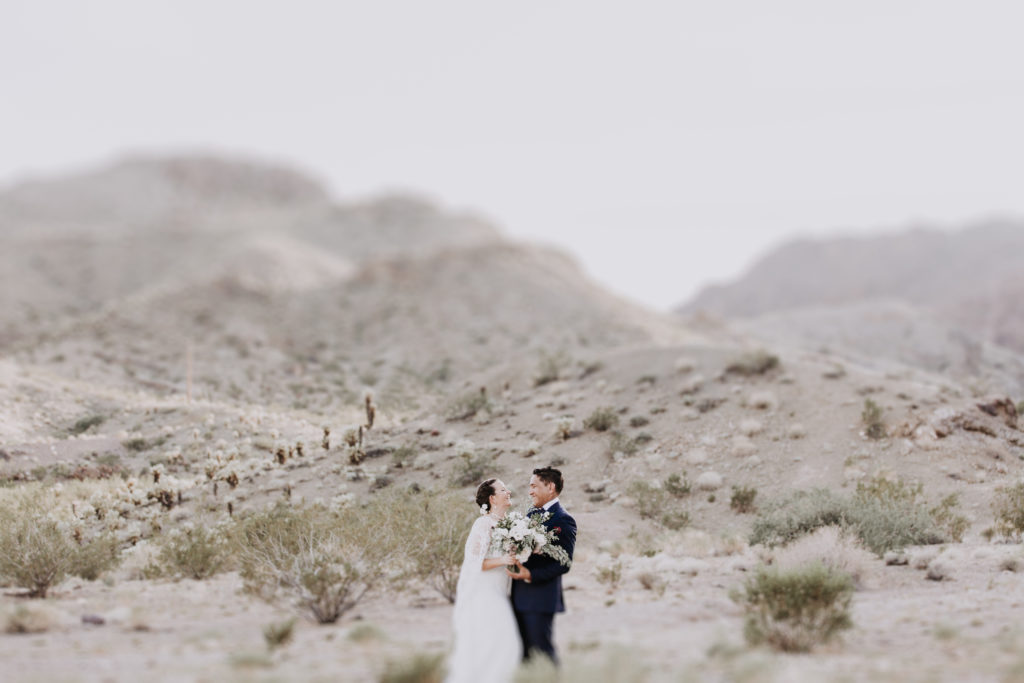 las vegas desert elopement bride and groom laugh in desert