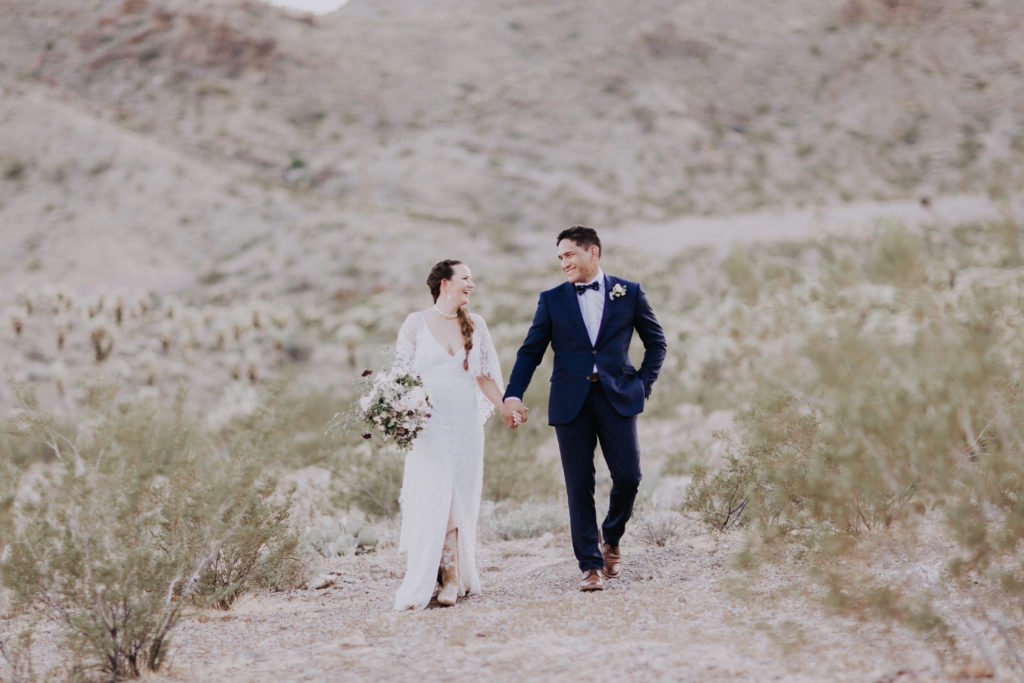 las vegas desert elopement bride and groom walk through desert