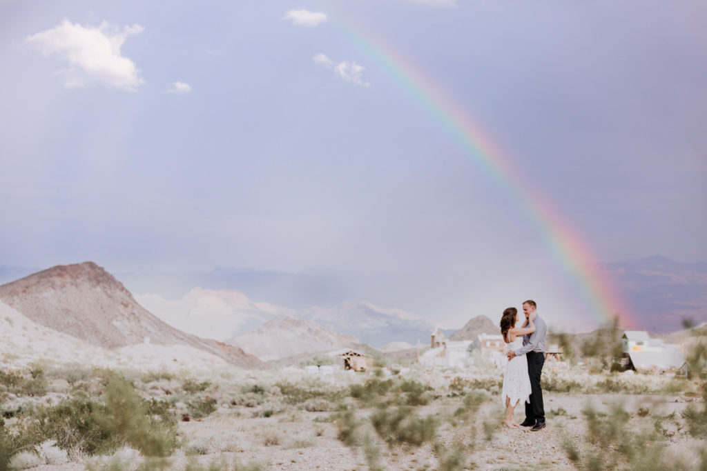 nelsons ghost town wedding pictures bride and groom pose with rainbow in background